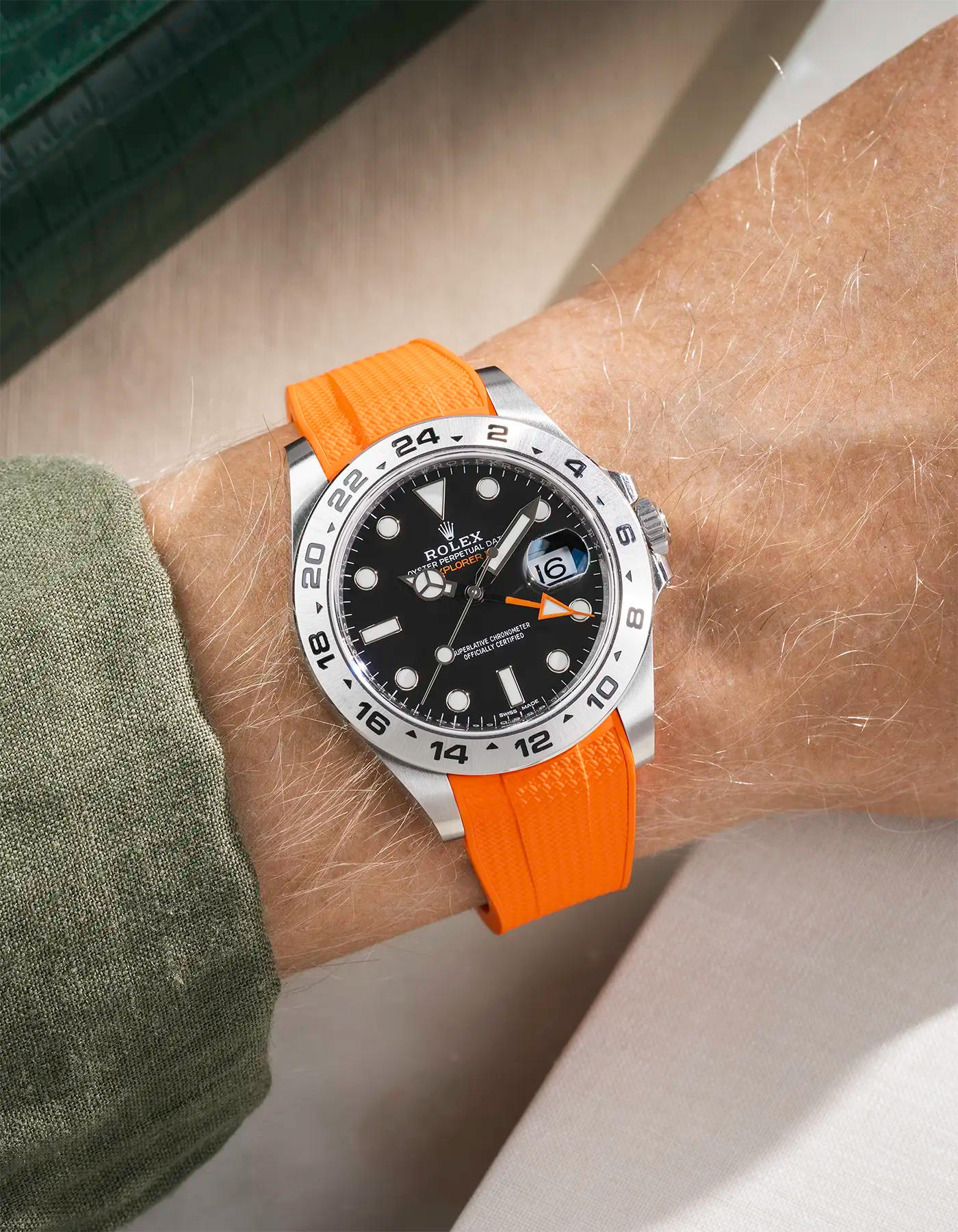Wrist shot on Vertech FKM Rubber Strap in orange with Integrated Original Clasp - Rolex Explorer 216570 on beige background