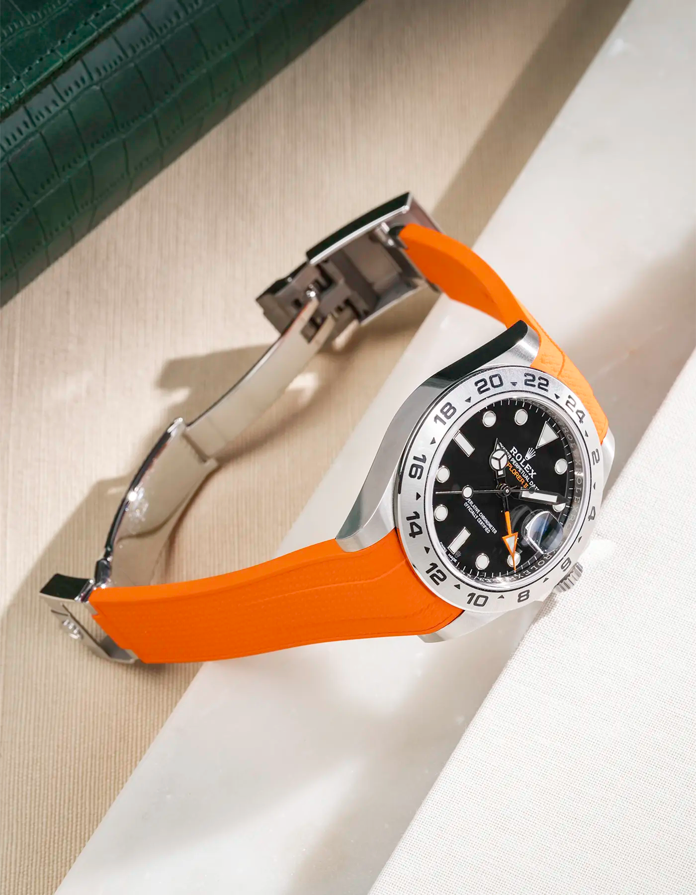 FKM rubber strap in Vertech integrated with original clasp for Rolex Explorer 216570 in orange, displayed on table with open clasp