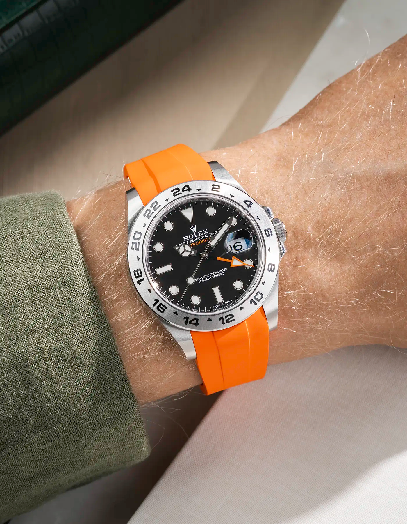 Wrist shot on orange FKM Rubber Strap Integrated with Original Clasp - Rolex Explorer 216570 over beige table