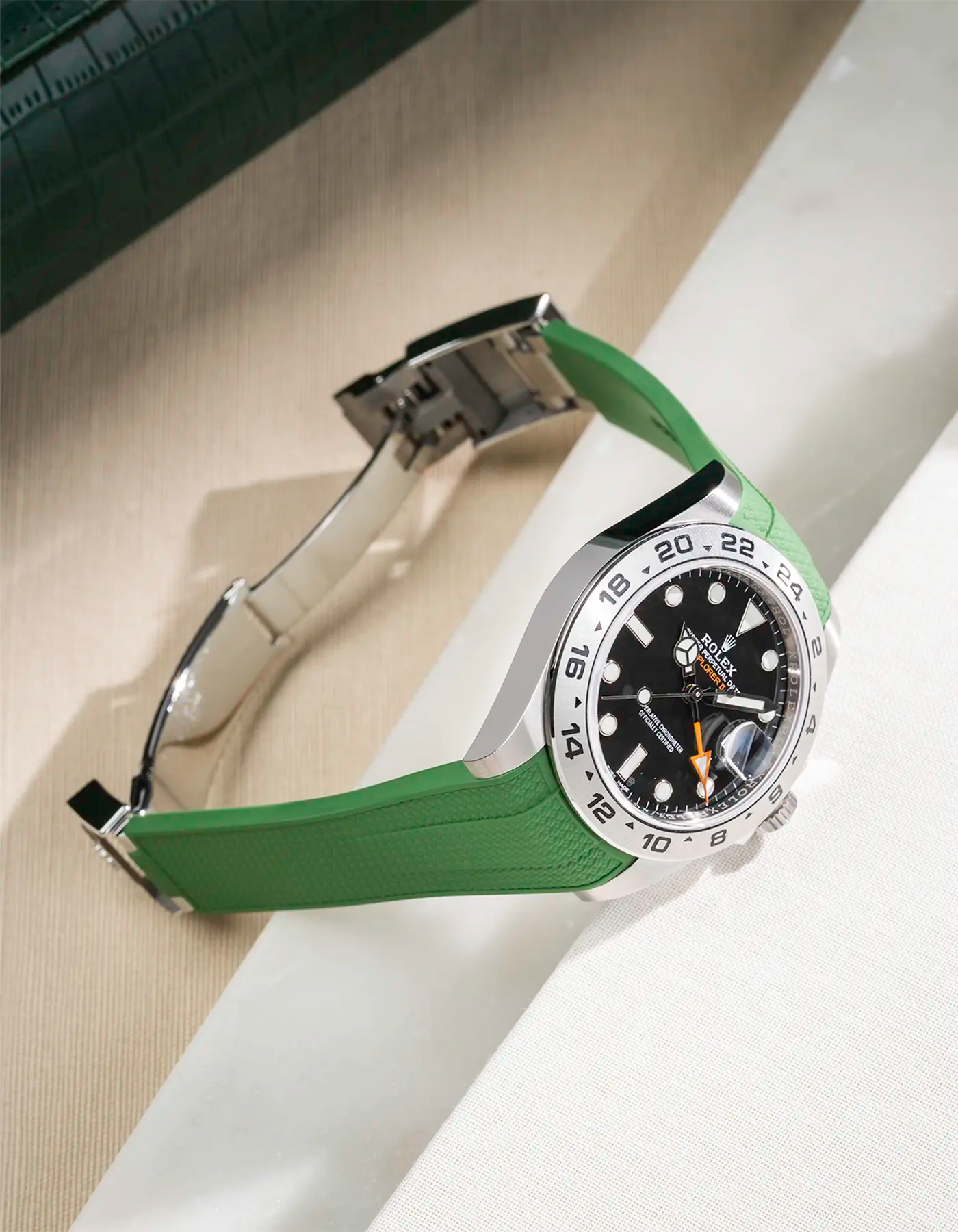 Vertech FKM rubber strap integrated with original clasp for Rolex Explorer 216570 in green, displayed on table with open clasp