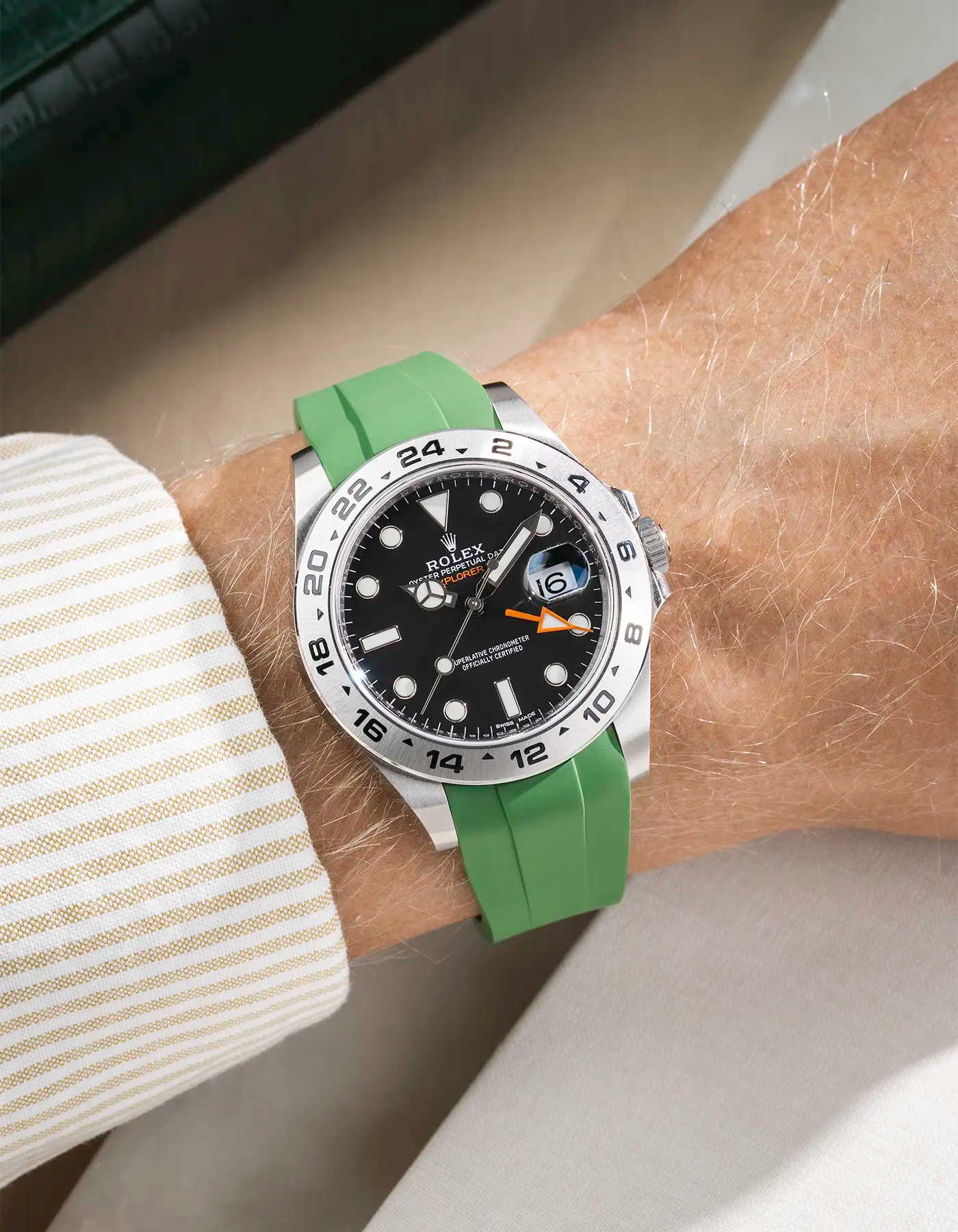 Wrist shot on classic smooth green FKM Rubber Strap Integrated with Original Clasp - Rolex Explorer 216570 on beige background