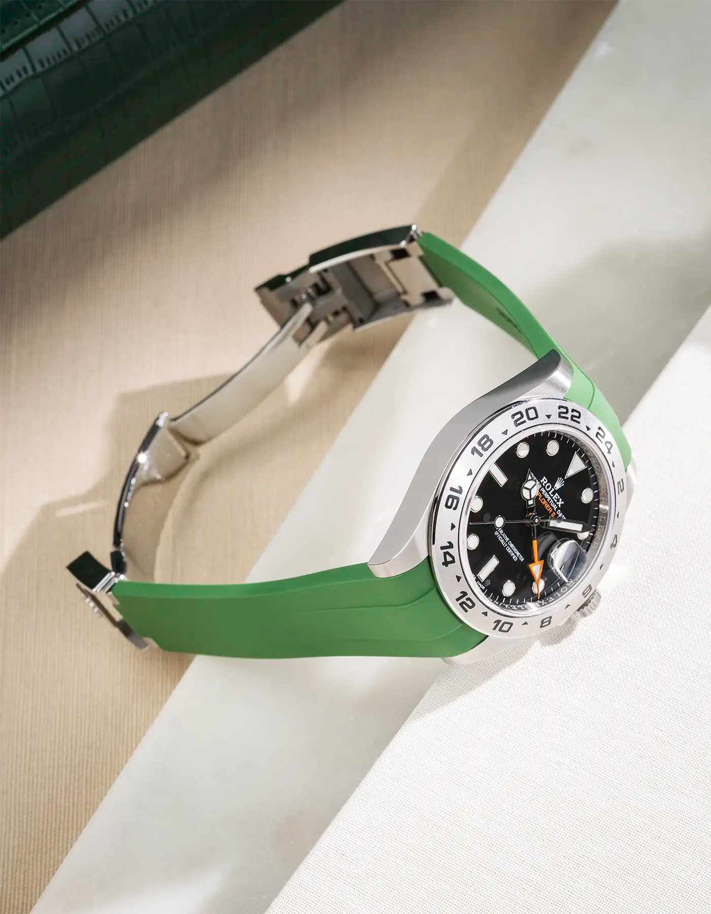 Green FKM rubber strap integrated with original clasp for Rolex Explorer 216570, displayed on table with open clasp