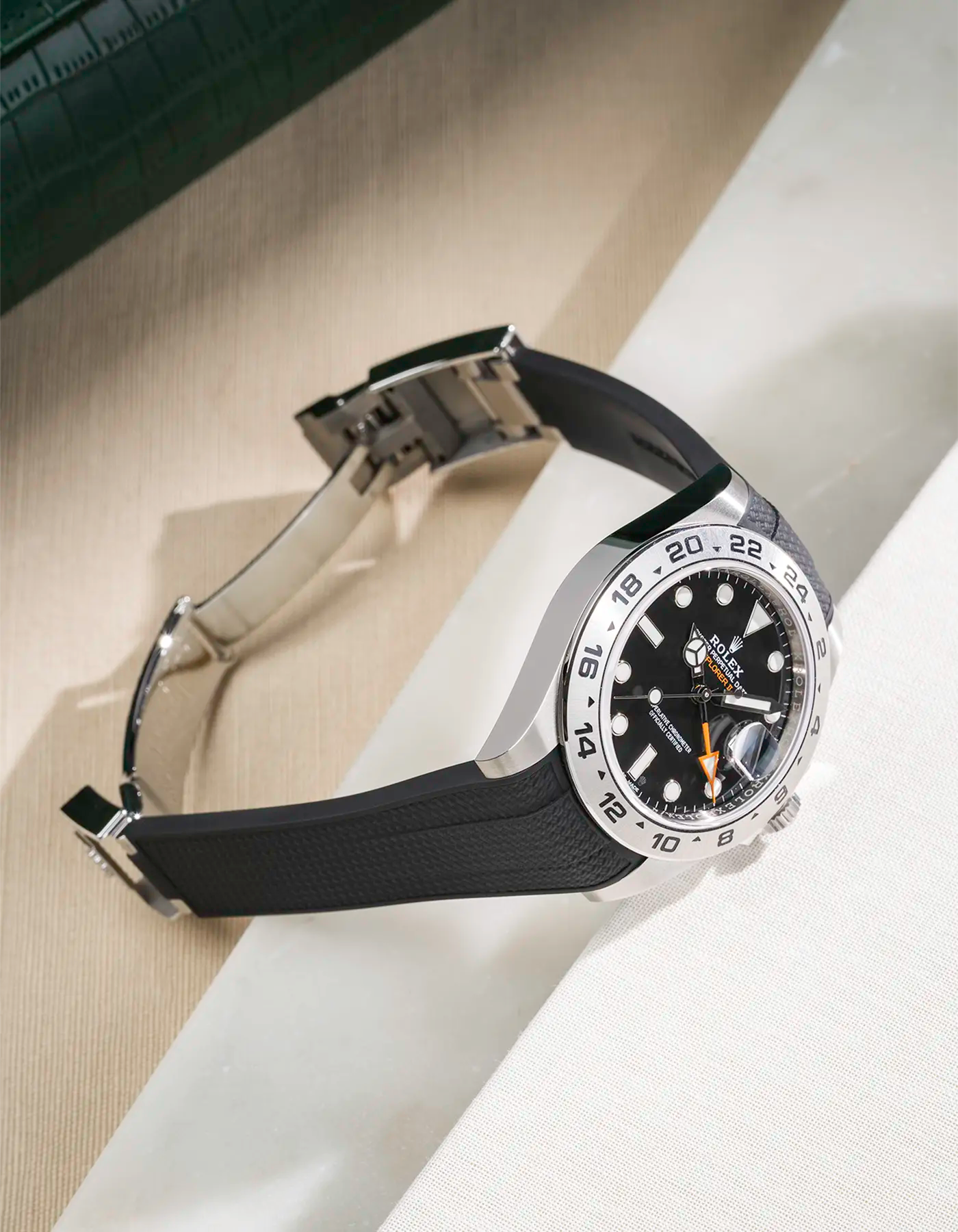 Vertech FKM rubber strap integrated with original clasp for Rolex Explorer 216570 in black, displayed on table with open clasp