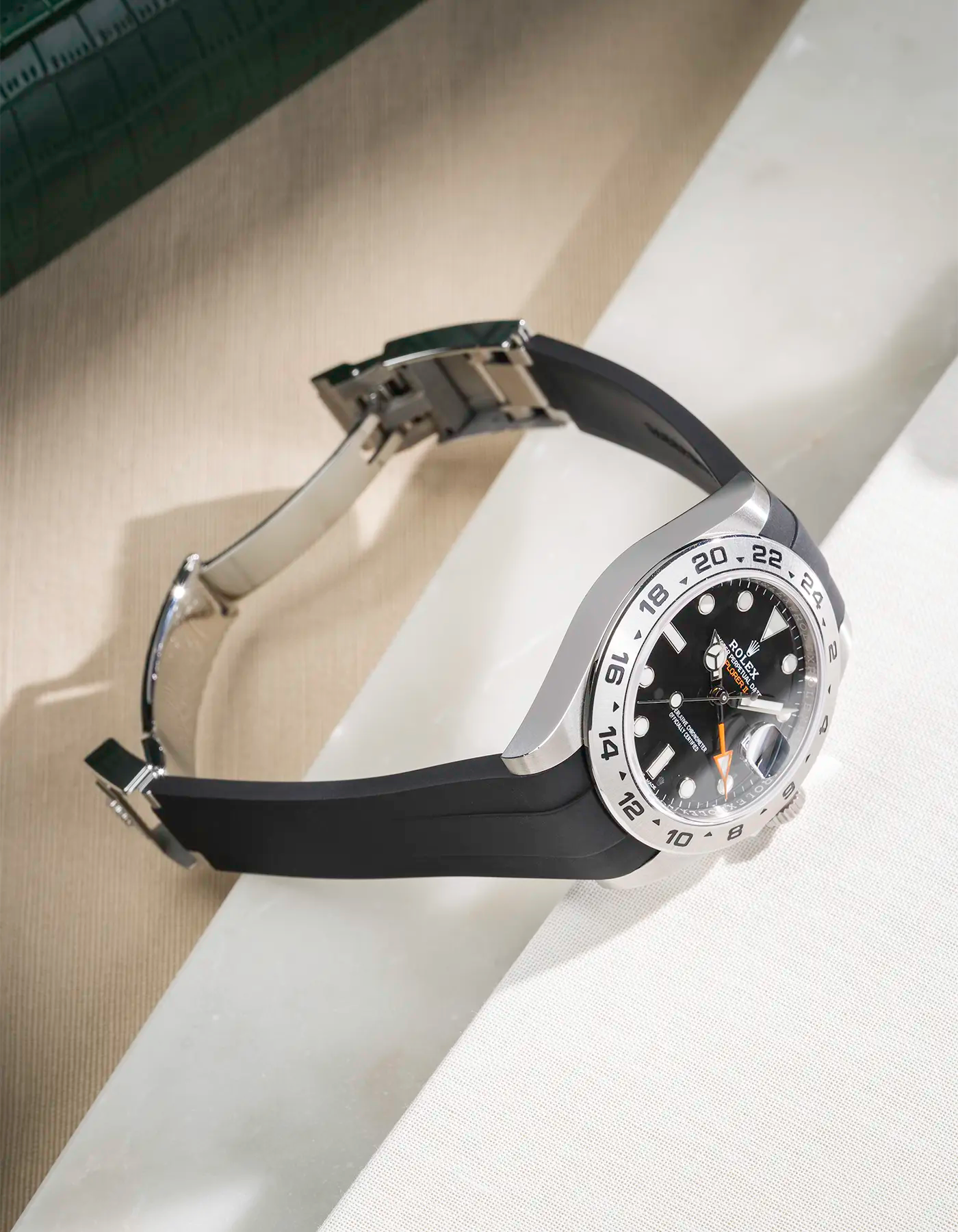 FKM rubber strap integrated with original clasp for Rolex Explorer 216570 in classic smooth black, displayed on table with open clasp
