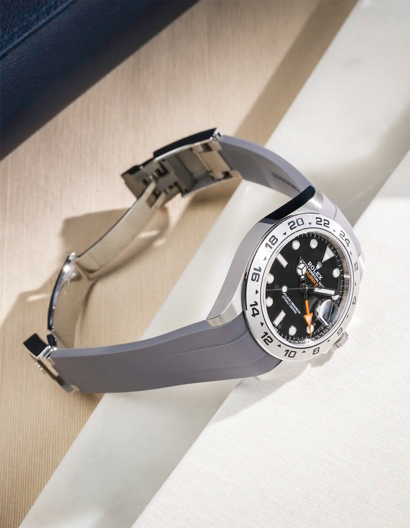 Grey FKM rubber strap integrated with original clasp for Rolex Explorer 216570, displayed on table with open clasp