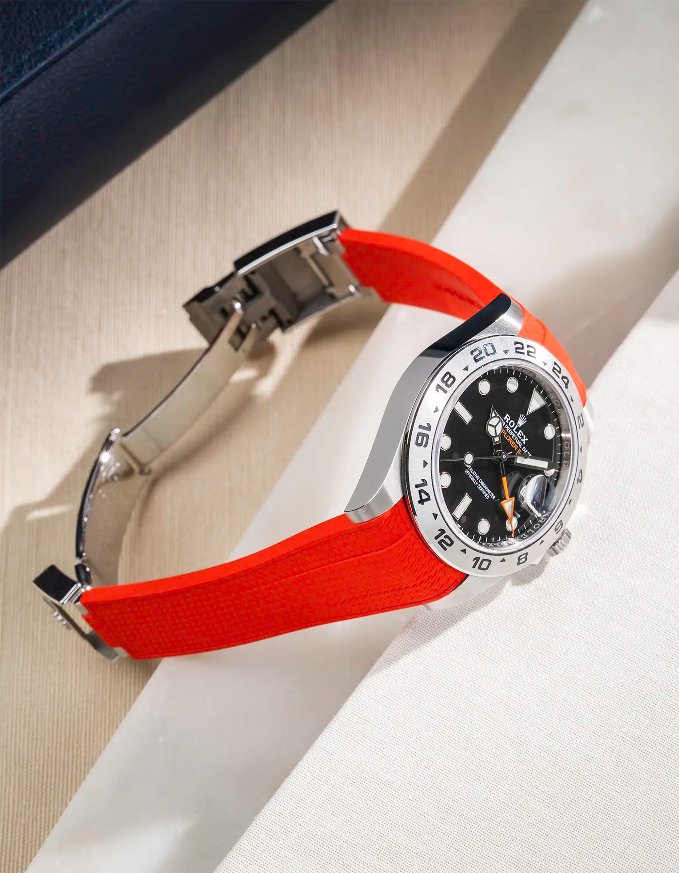 Vertech FKM rubber strap integrated with original clasp for Rolex Explorer 216570 in red, displayed on table with open clasp