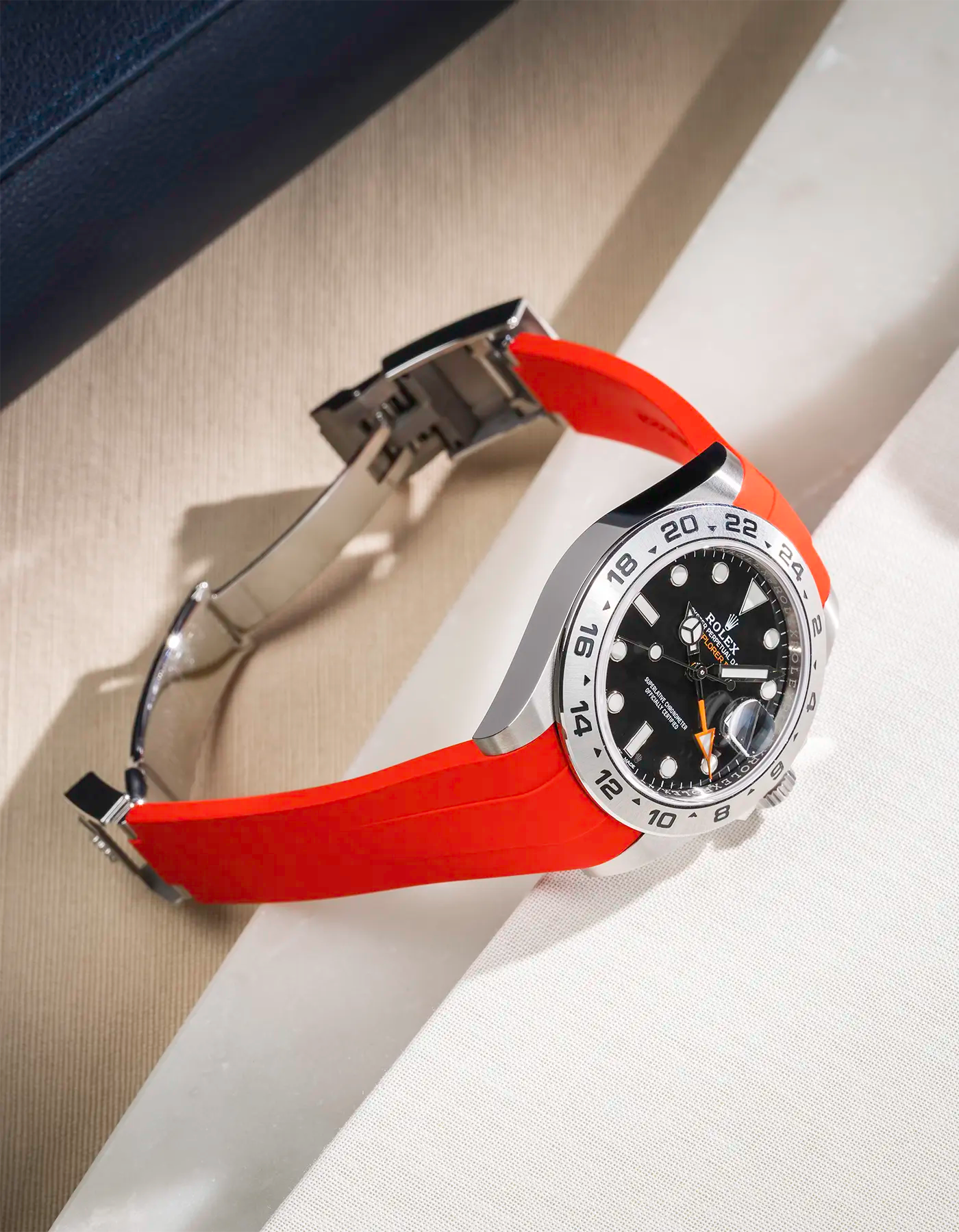Classic Smooth Red FKM rubber strap integrated with original clasp for Rolex Explorer 216570, displayed on table with open clasp