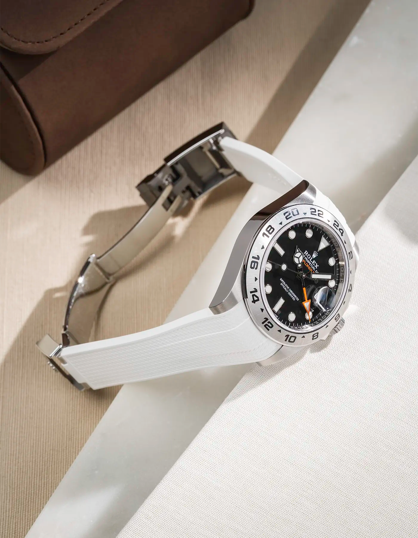 FKM rubber strap in Vertech integrated with original clasp for Rolex Explorer 216570 in white, displayed on a beige and white table with open clasp