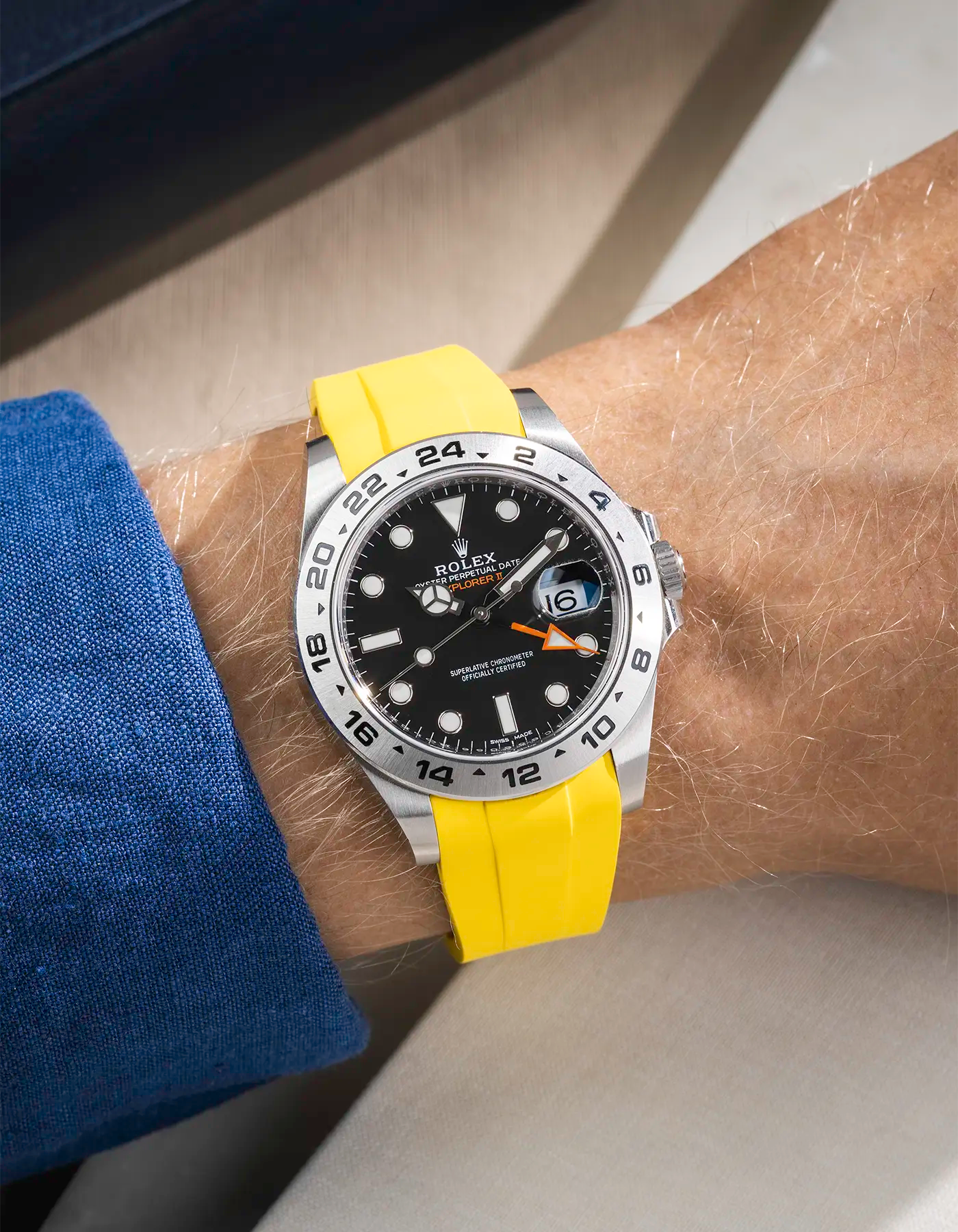 Wrist shot on yellow FKM Rubber Strap Integrated with Original Clasp - Rolex Explorer 216570 on beige background