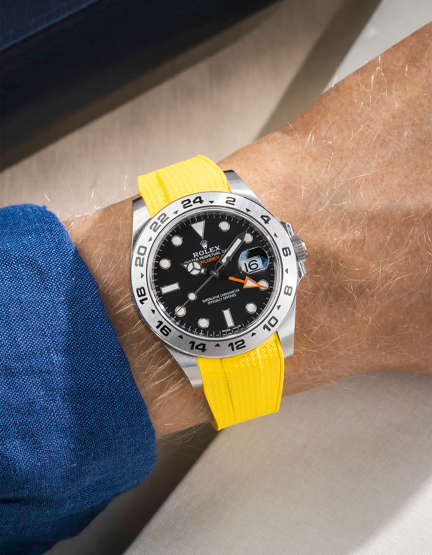 Wrist shot on Vertech FKM Rubber Strap in Yellow with Integrated Original Clasp - Rolex Explorer 216570 over a table with watch roll