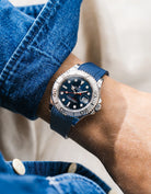 Close-up of a person wearing a Rolex YachtMaster 2 126622 / 116622 model watch with a dark blue shirt sleeve and a navy blue vertech FKM rubber watch strap from Wristbuddys
