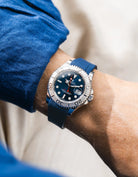 Close-up of a person wearing a Rolex YachtMaster 2 126622 / 116622 model watch with a dark blue shirt sleeve and a navy blue FKM rubber watch strap from Wristbuddys