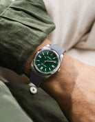 Grey integrated FKM rubber strap with original clasp on Rolex Oyster Perpetual 41 124300 green dial wrist shot