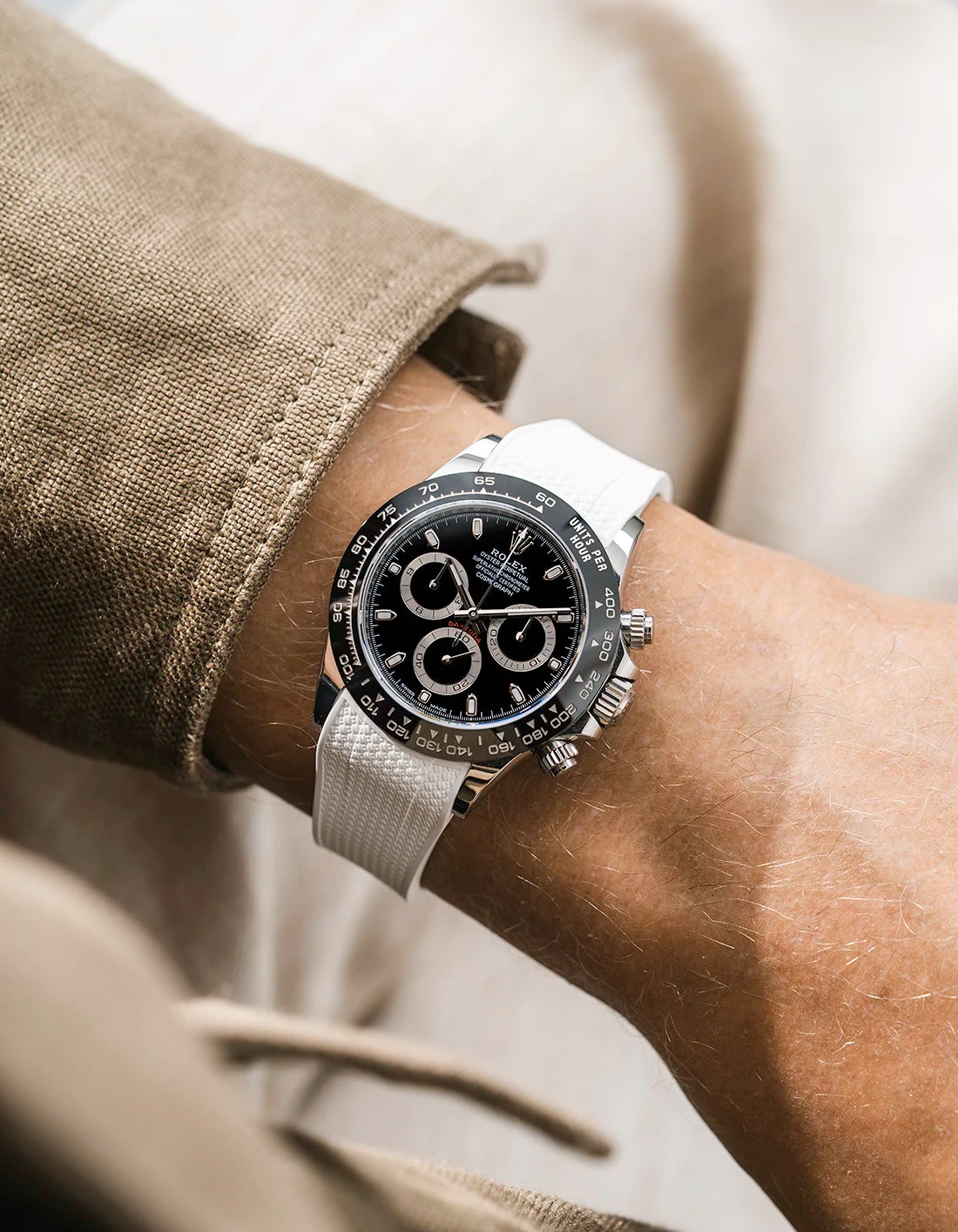 White integrated Vertech FKM rubber strap with original clasp on Rolex Daytona 116500 black dial ceramic bezel wrist shot textured surface