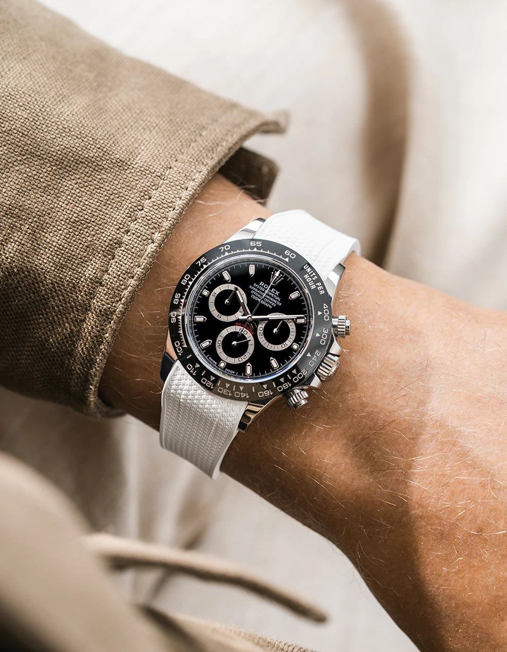 White integrated Vertech FKM rubber strap with original clasp on Rolex Daytona 116500 black dial ceramic bezel wrist shot textured surface