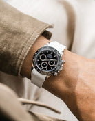 White integrated Vertech FKM rubber strap with original clasp on Rolex Daytona 116500 black dial ceramic bezel wrist shot textured surface