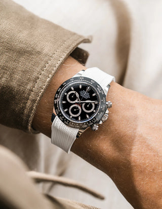 White integrated Vertech FKM rubber strap with original clasp on Rolex Daytona 116500 black dial ceramic bezel wrist shot textured surface