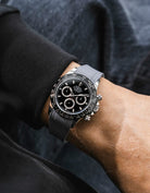 Grey integrated Vertech FKM rubber strap with original clasp on Rolex Daytona 116500 black dial ceramic bezel wrist shot textured surface