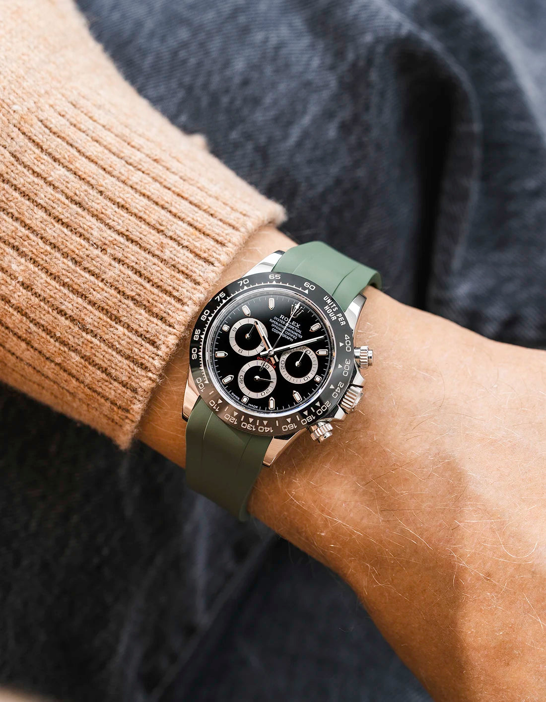 Military green integrated FKM rubber strap with original clasp on Rolex Daytona 116500 black dial ceramic bezel wrist shot classic smooth surface