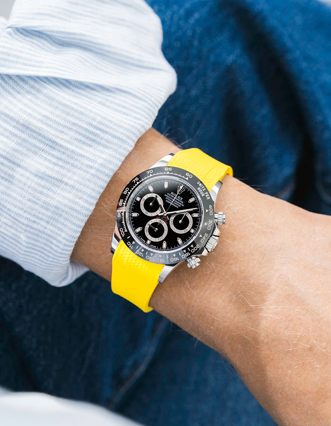 Yellow integrated Vertech FKM rubber strap with original clasp on Rolex Daytona 116500 black dial ceramic bezel wrist shot textured surface