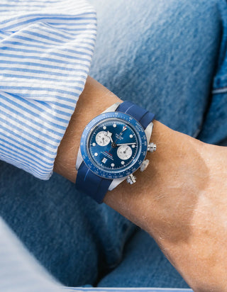 Wristbuddys navy blue rubber strap on Tudor Black Bay Chrono — wrist lifestyle shot with striped shirt and jeans