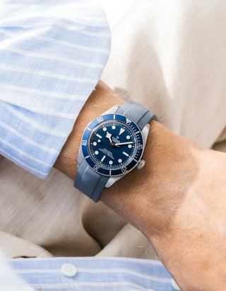 Wristbuddys grey rubber strap on Tudor Black Bay 58 Navy Blue — wrist lifestyle shot with striped shirt