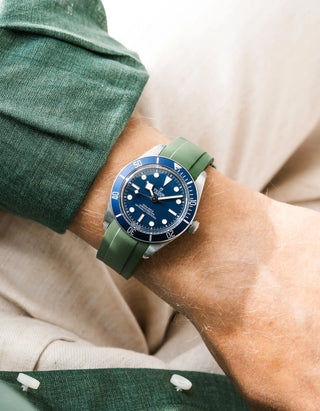Wristbuddys green rubber strap on Tudor Black Bay 58 Navy Blue — wrist lifestyle shot with green shirt