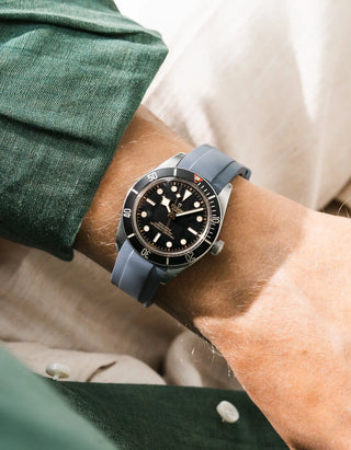 Wristbuddys grey rubber strap on Tudor Black Bay 58 Black — wrist lifestyle shot with green shirt