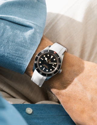 Wristbuddys white rubber strap on Tudor Black Bay 58 Black — wrist lifestyle shot with blue shirt