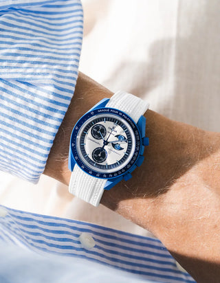 White rubber strap for OMEGA x Swatch MoonSwatch Mission to the Super Blue Moonphase, worn on the wrist in a lifestyle photo
