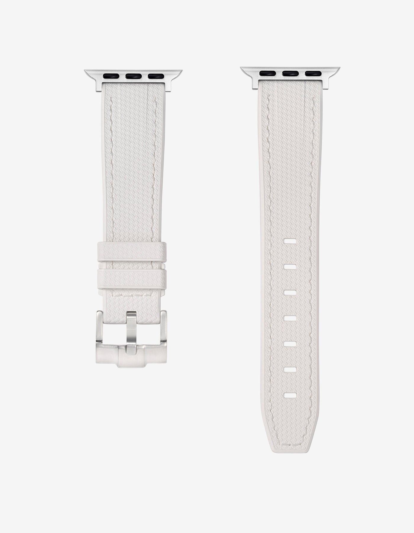 A White rubber apple watch band in detail with silver buckle