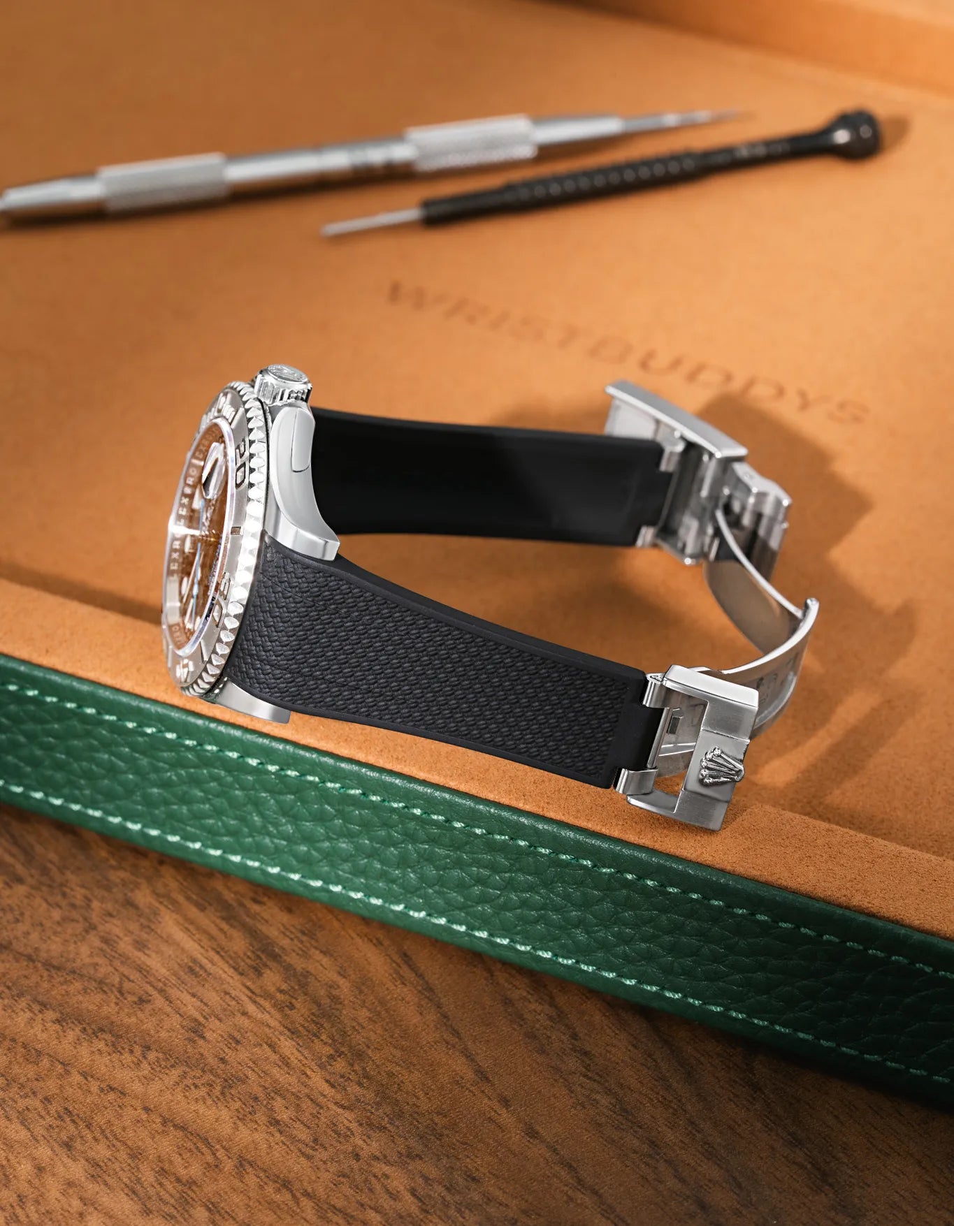 Black Vertech FKM rubber strap for Rolex Yacht-Master 116622 and 126622, integrated seamless fit with original clasp, resting on a leather valet tray.