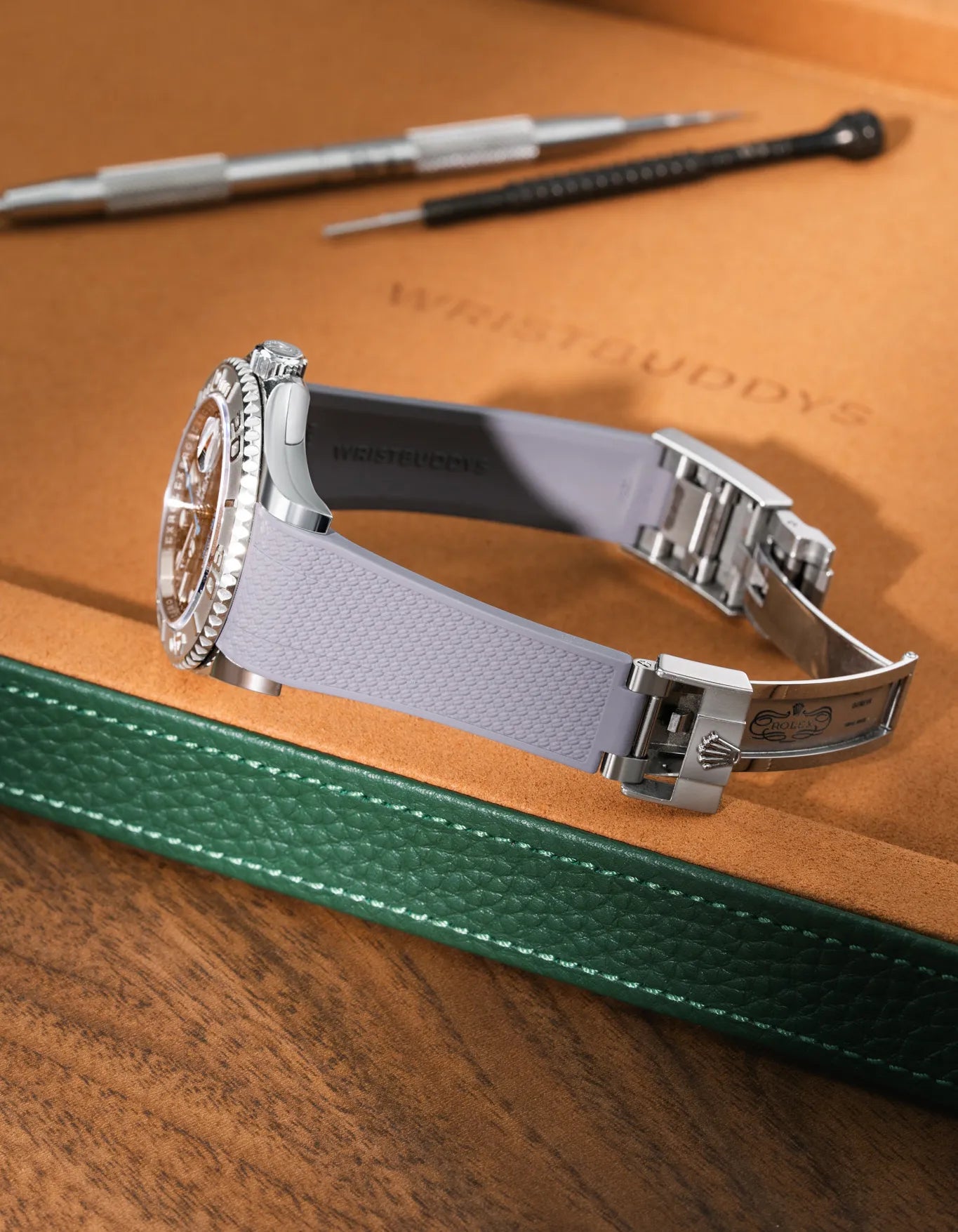 Grey FKM rubber strap for Rolex Yacht-Master 116622 and 126622, integrated case fit for original clasp, resting on a leather watch tray.