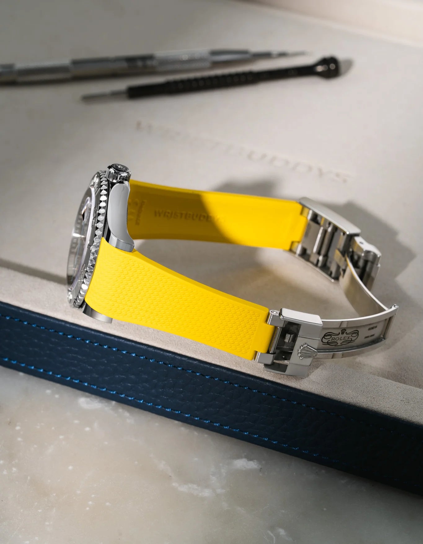 Yellow integrated FKM rubber watch band for Rolex Yacht-Master 116622 & 126622, Vertech textured finish with original clasp, resting on a white valet tray.