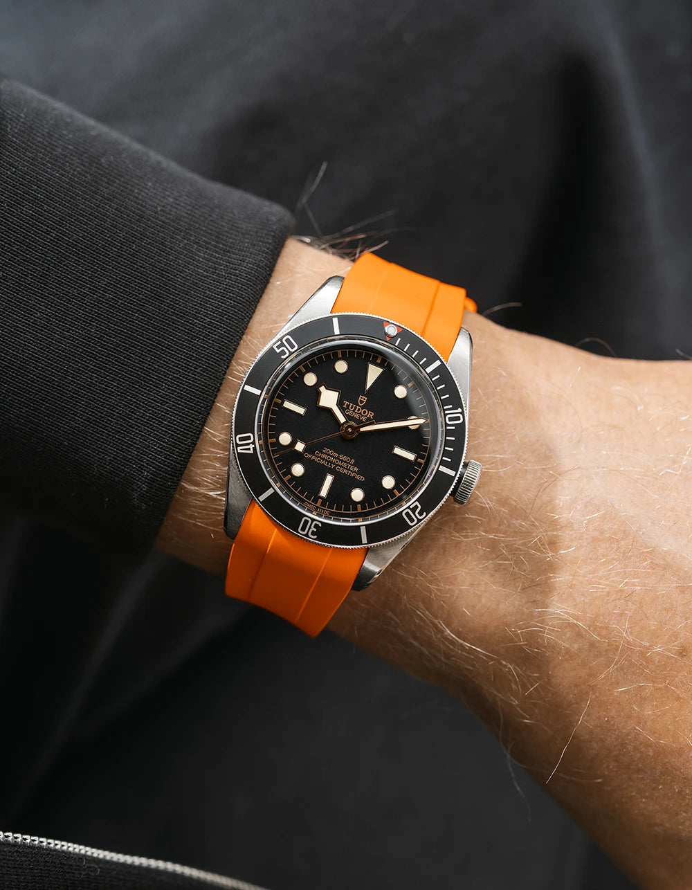 orange FKM rubber watch strap from Wristbuddys with a Tudor BB41 Heritage black dial on a person's wrist