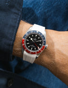 Tudor GMT watch on a person's wrist with a white FKM rubber watch strap from Wristbuddys and red & blue accents on the bezel