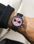 Black FKM rubber watch strap from Wristbuddys with a Tudor Chrono pink dial on a person's wrist