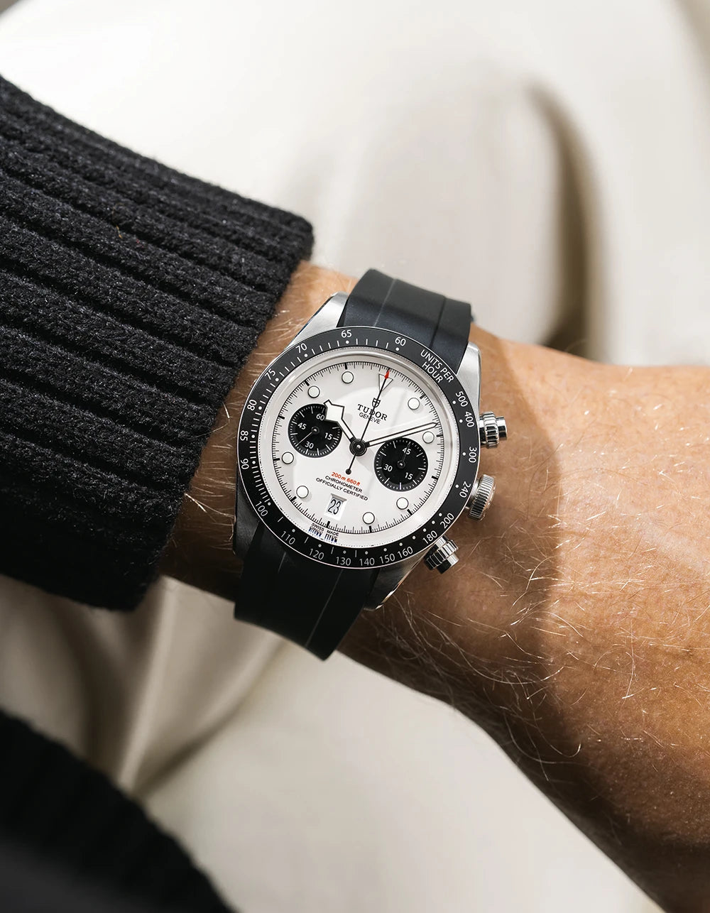 Black FKM rubber watch strap from Wristbuddys with a Tudor Chrono white dial on a person's wrist