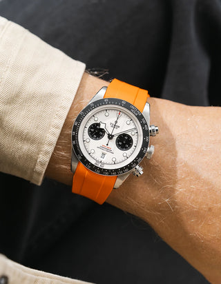 orange FKM rubber watch strap from Wristbuddys with a Tudor Chrono white dial on a person's wrist