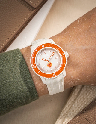 Beige Vertech rubber strap mounted on Blancpain X Swatch Arctic Ocean shown on wrist with silver buckle