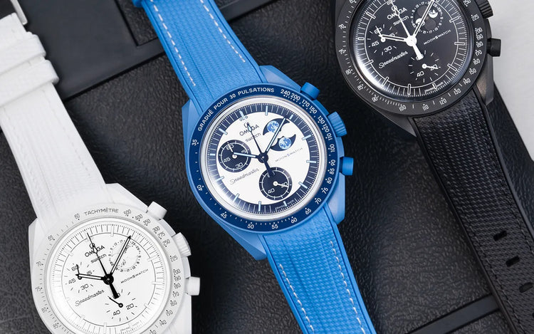 Three Omega x Swatch MoonSwatch watches showcasing Wristbuddys best selling rubber straps in blue, white, and black – hero image for Best Sellers page.
