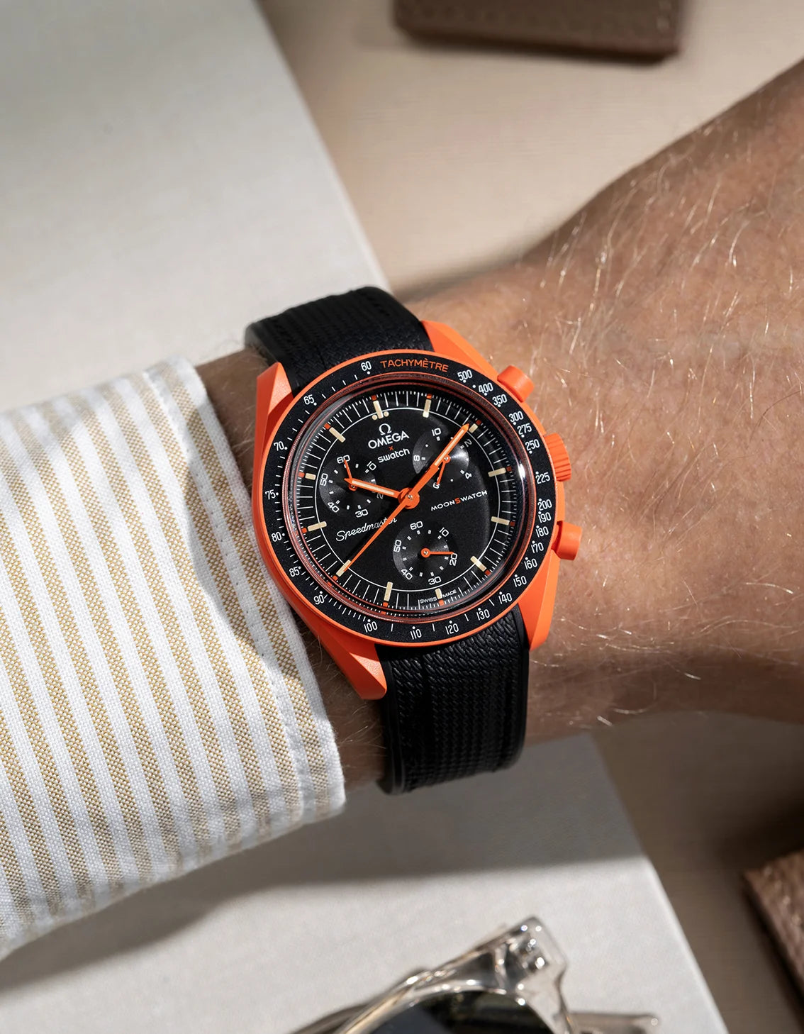 Wrist shot showing black rubber strap for Omega X Swatch MoonSwatch Mission On Earth Lava