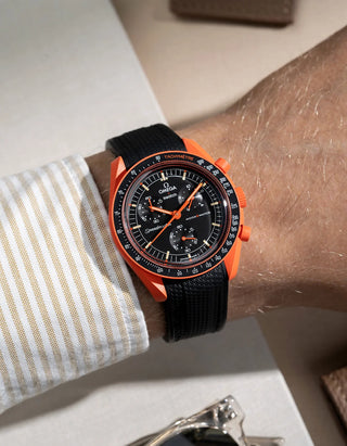 Wrist shot showing black rubber strap for Omega X Swatch MoonSwatch Mission On Earth Lava