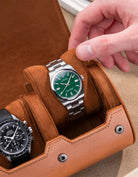 Brown watch roll with Sliding System, featuring a Rolex Oyster Perpetual with a green dial and an Omega Speedmaster, securely placed on soft suede sliding cushions for elegant and safe storage.