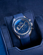 Navy blue watch roll with Sliding System, showcasing an Omega Speedmaster Professional GMT with a blue dial and matching rubber strap, placed on a soft suede sliding cushion for secure and stylish storage