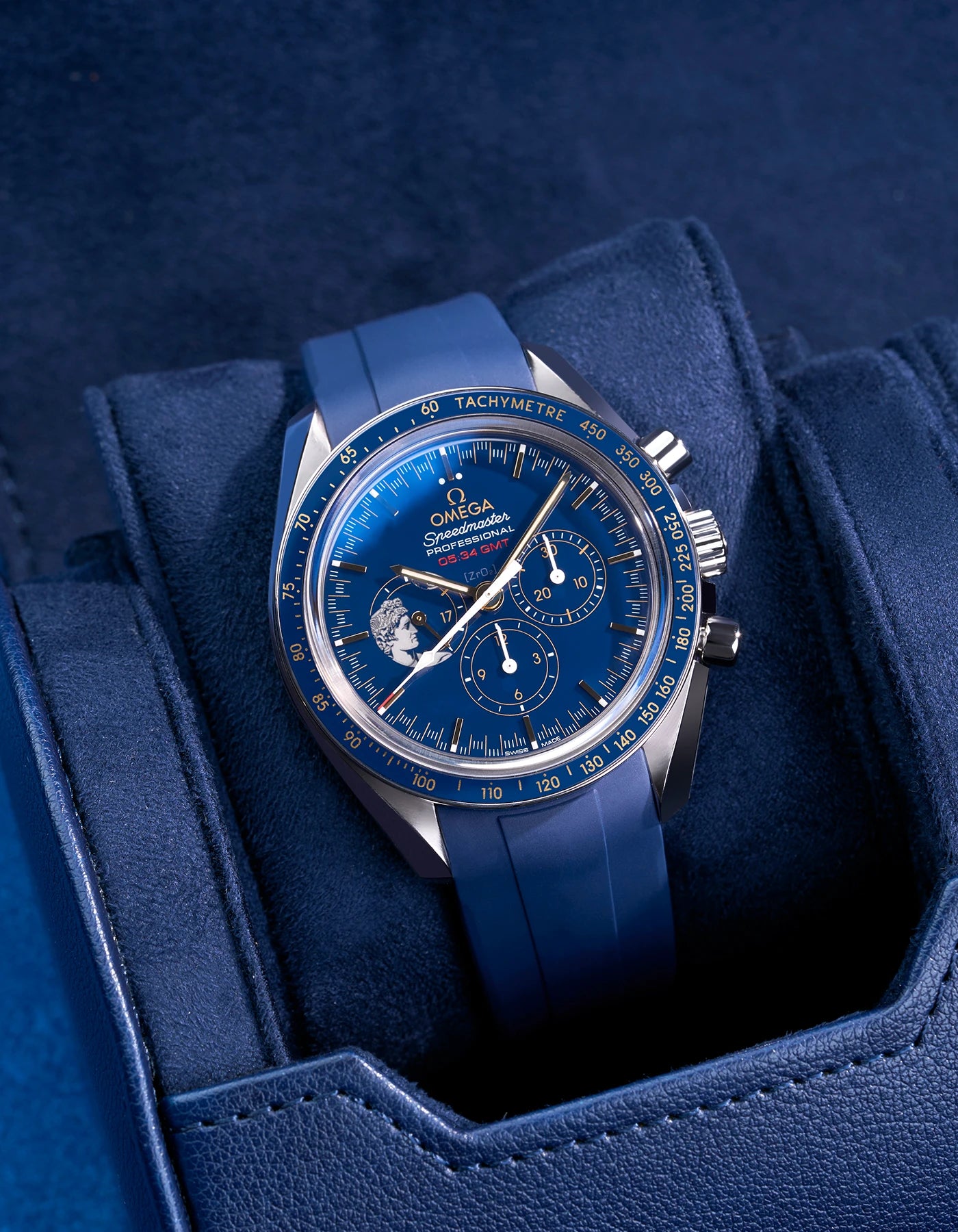 Navy blue watch roll with Sliding System, showcasing an Omega Speedmaster Professional GMT with a blue dial and matching rubber strap, placed on a soft suede sliding cushion for secure and stylish storage