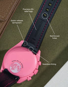 Black curved rubber strap with pink stitching, seamless case integration, quick-release spring bars and precision logo detailing