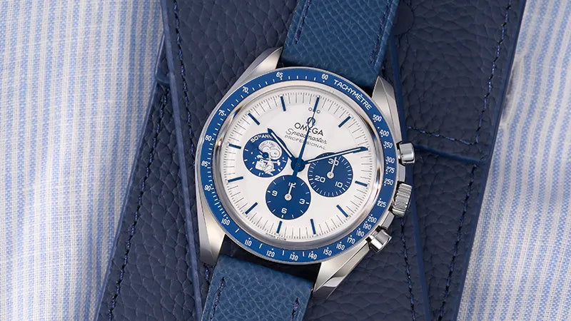 Omega Speedmaster Snoopy Edition paired with a navy blue handmade Epsom leather watch strap from Wristbuddys, showcasing premium texture and timeless elegance."