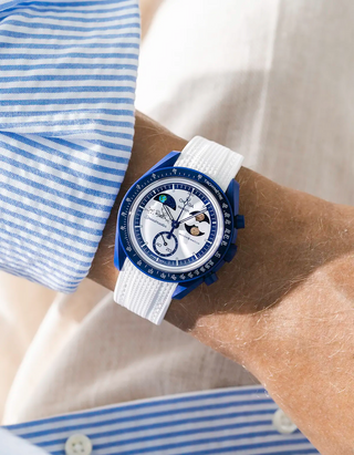 Premium white rubber watch strap worn on wrist with Omega x Swatch MoonSwatch Mission To Earthphase - Moonshine Gold