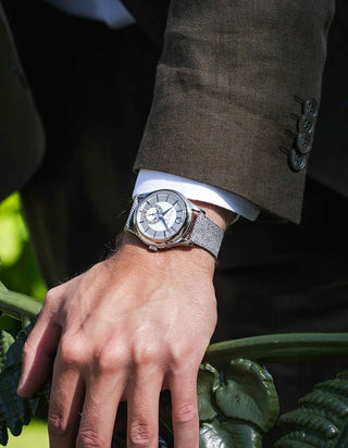 Light Grey Denim Strap on Patek Philippe – wrist shot with a brown suit